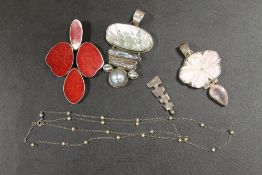 A COLLECTION OF FOUR SILVER AND WHITE METAL PENDANTS, ONE WITH CHAIN