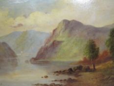 A PAIR OF GILT FRAMED OIL ON BOARD PAINTINGS OF MOUNTAINOUS LAKE SCENES SIGNED T WOOD