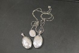 THREE VINTAGE SILVER PENDANT LOCKETS