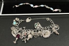 AN ORNATE SILVER CHARM TOGETHER WITH ANOTHER BRACELET