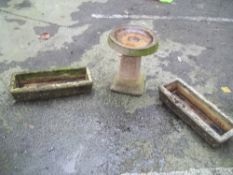 A CONCRETE BIRD BATH WITH 2 CONCRETE PLANTERS