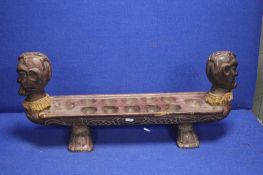 AN UNUSUAL CARVED TRIBAL RACK WITH HEAD TO EACH END EACH WITH A LIZARD ON TOP