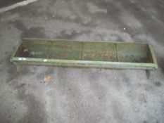 A LARGE CAST IRON CHICKEN FEEDER TROUGH