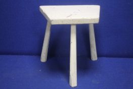 AN ANTIQUE RUSTIC MILKING STOOL