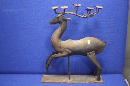A METAL CANDLE HOLDER IN THE FORM OF A DEER