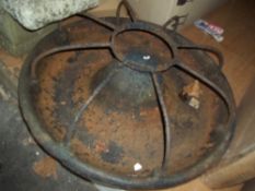 AN ANTIQUE CAST IRON ROUND CHICKEN FEEDER THROUGH PLANTER