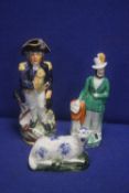 TWO CONTINENTAL STYLE FIGURES TOGETHER WITH A STAFFORSHIRE STYLE FIGURE OF A SHEEP