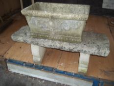 A CONCRETE GARDEN BENCH AND PLANTER