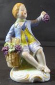 sitzender Junge mit Traubenkorb "Sitzendorf" bemalt, H-9 cm