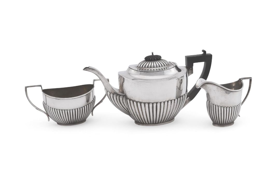 A MATCHED SILVER OVAL THREE PIECE TEA SERVICE, WILLIAMS (BIRMINGHAM) LTD AND H. V. PITHEY & CO.