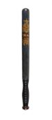 A green painted and ebonised wood truncheon