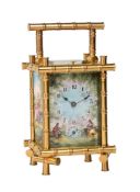 A FRENCH GILT BAMBOO CASED REPEATING ALARM CARRIAGE CLOCK WITH PAINTED FIRED ENAMEL PANELS