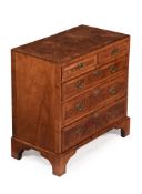 A GEORGE II BURR AND FIGURED WALNUT CHEST OF DRAWERS, CIRCA 1730