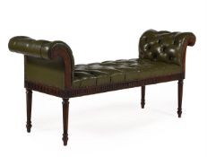 A MAHOGANY AND BUTTONED GREEN LEATHER UPHOLSTERED STOOL OR WINDOW SEAT, IN GEORGE III STYLE