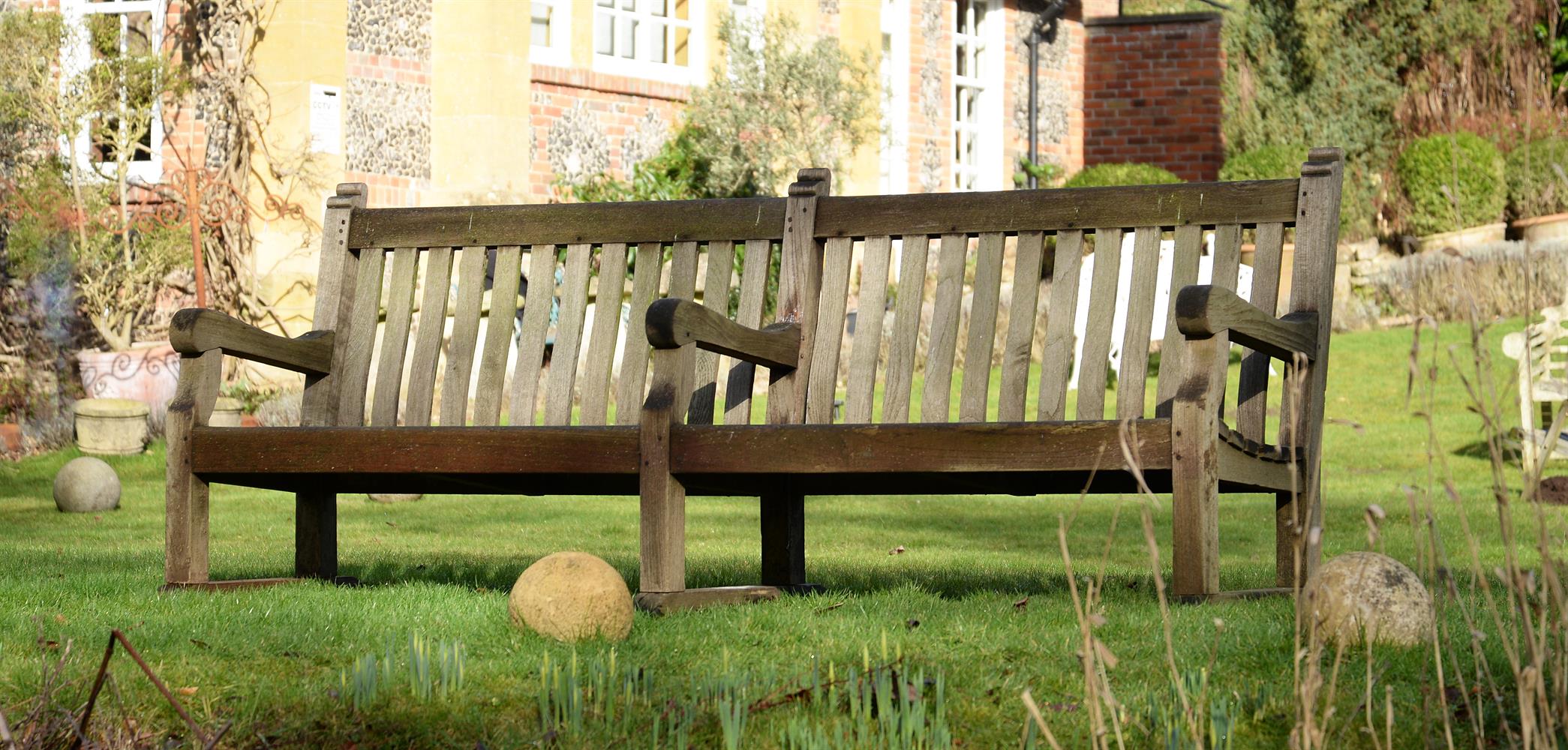A LARGE WEATHERED HARDWOOD GARDEN BENCH, EARLY/MID 20TH CENTURY - Image 2 of 2