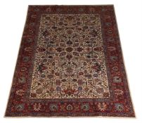 A TABRIZ CARPET, signed by the Master Weaver Kamran, approximately 324 x 224cm