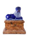 A PAIR OF FRENCH FAIENCE BLUE-GLAZED AND WHITE MODELS OF RECUMBENT LIONS, PROBABLY LUNEVILLE