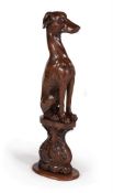 A REGENCY CARVED OAK MODEL OF A GREYHOUND, CIRCA 1820
