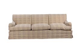 A PAIR OF MAHOGANY AND UPHOLSTERED THREE-SEAT SOFAS IN THE MANNER OF HOWARD & SONS
