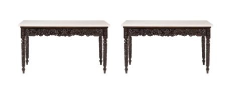 Y A PAIR OF ANGLO INDIAN EBONY CONSOLE TABLES WITH LATER MARBLE TOPS