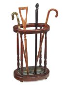 A LATE VICTORIAN WALNUT OVAL STICK STAND