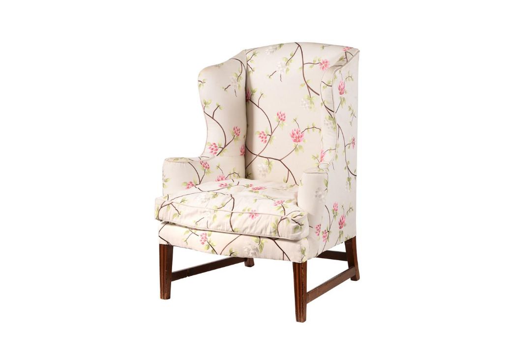 A MAHOGANY AND UPHOLSTERED WING ARMCHAIR IN GEORGE III STYLE