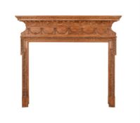 A STRIPPED PINE AND COMPOSITION CHIMNEY PIECE IN GEORGE III STYLE