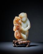 A rare Chinese pale celadon and brown jade model of a 'monkey and infant'