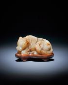 A Chinese white and russet jade model of a horse