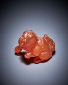 A Chinese amber carving of a lion