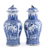 A pair of Chinese blue and white vases and covers