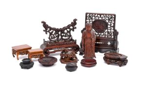A group of Chinese wood stands and a boxwood figure of Buddha