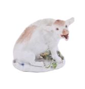 A MEISSEN MODEL OF A WILD BOAR SEATED ON ITS HAUNCHES