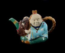 A MINTON MAJOLICA TEAPOT AND COVER MODELLED AS A CHINESE-FIGURE