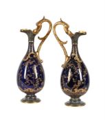 A PAIR OF DOULTON BURSLEM BLUE-GROUND AND GILT SLENDER EWERS