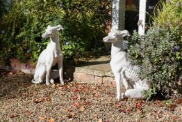 A PAIR OF WHITE GLAZED TERRACOTTA MODELS OF SEATED GREYHOUNDS