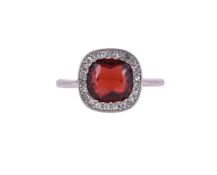 A GARNET AND DIAMOND CLUSTER RING