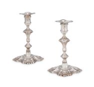A PAIR OF GEORGE II CAST SILVER CANDLESTICKS