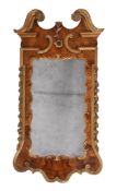 A GEORGE II FIGURED WALNUT AND PARCEL GILT WALL MIRROR, SECOND QUARTER 18TH CENTURY