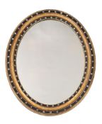 AN IRISH CUT GLASS, GILTWOOD AND EBONISED OVAL WALL MIRROR, IN GEORGE III STYLE, LATE 19TH CENTURY