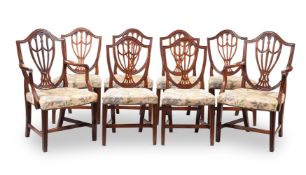 A SET OF EIGHT GEORGE III MAHOGANY DINING CHAIRS, AFTER DESIGNS BY GEORGE HEPPLEWHITE