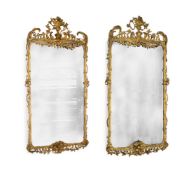 A LARGE PAIR OF CARVED GILTWOOD AND COMPOSITION WALL MIRRORS, IN GEORGE III STYLE