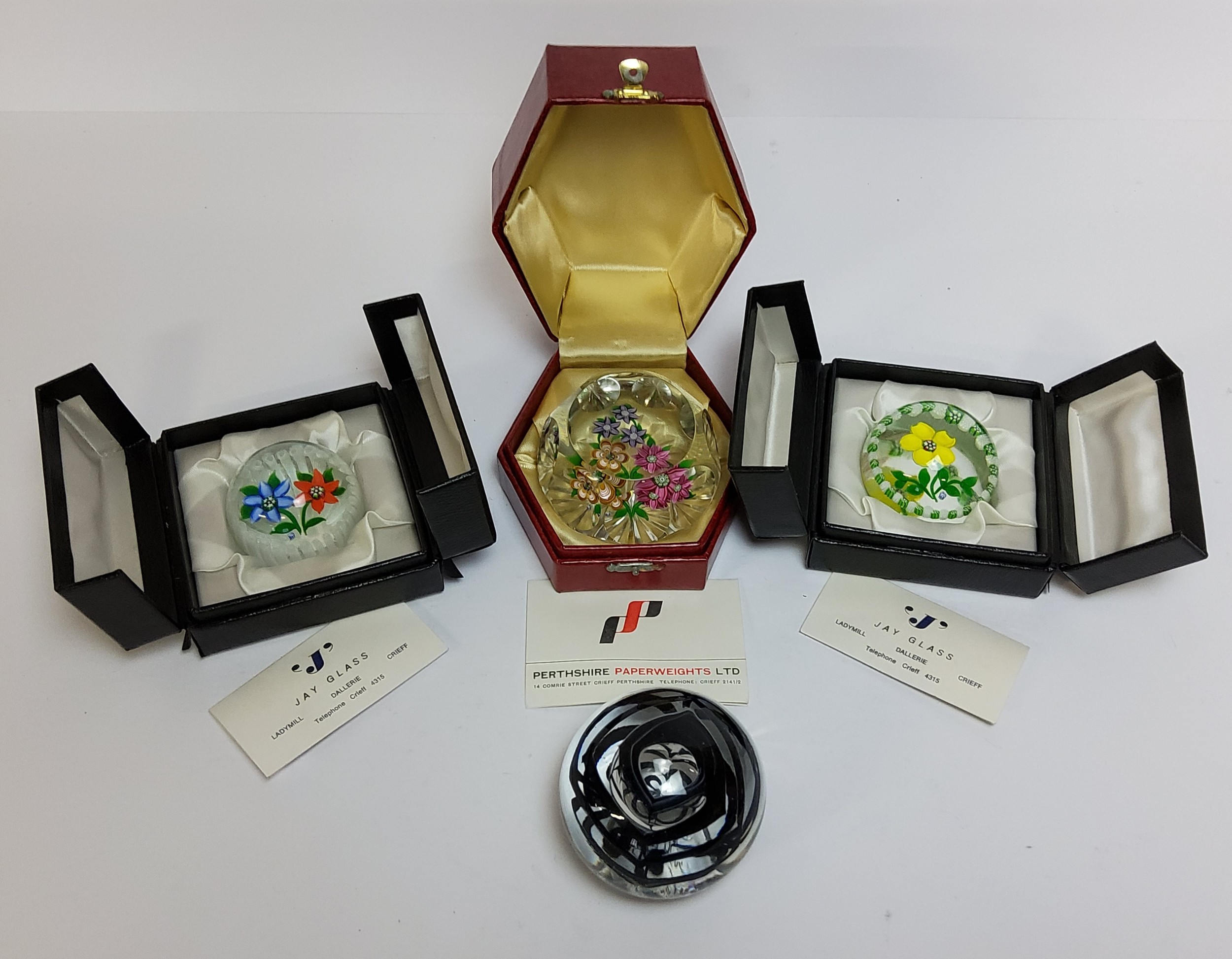 A John Deacon 'Jay Glass' paperweight, a floral duo set above a latticino basket. no 16/101,