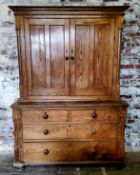 An early Victorian farmhouse pitch pine housekeeper's cupboard, the oversailing ogee cornice above