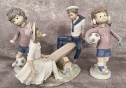 Lladro Sport Billy girl & boy footballers c.1978; a Lladro Seesaw figural group (3)