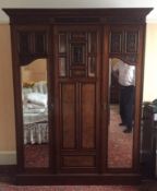 A Victorian burr walnut and mahogany double wardrobe, the oversailing cornice above central blind