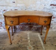 A small kidney shaped dressing table with one long flanked by two short drawers height 74.5cm x