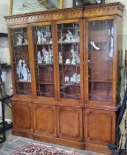 A Regency Revival flamed mahogany library breakfront bookcase, 20th century. Excellent condition.
