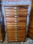 A late 19th century farmhouse pine bank of sixteen collectors drawers / printers drawers with