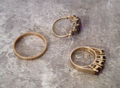 A 9ct gold wedding band 3.17g; a 9ct gold ring set with four oval purple amethysts 3.55g; a 9ct gold